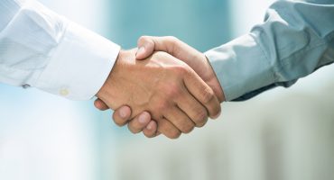 Close-up image of a firm handshake standing for a trusted partnership